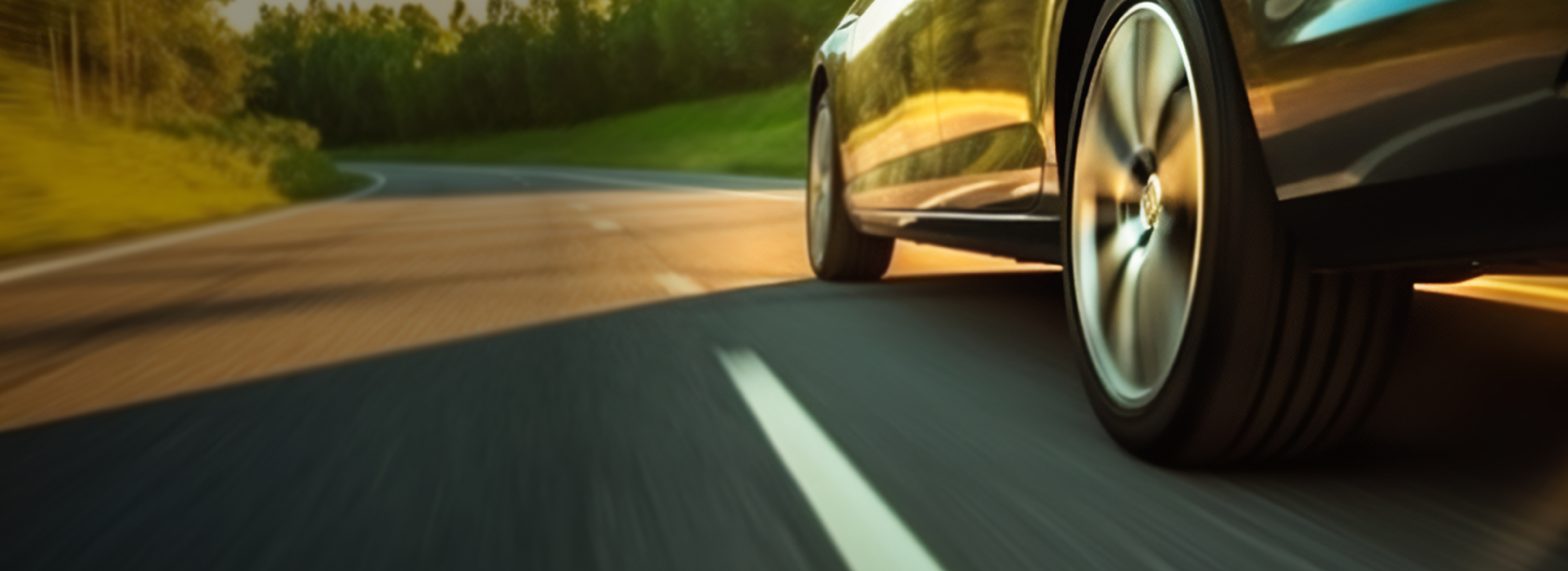 Close-up of car tire driving on open road.